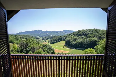 a view from the balcony of a house with a view of the mountains at Holiday House Konuško in Šmarje pri Jelšah