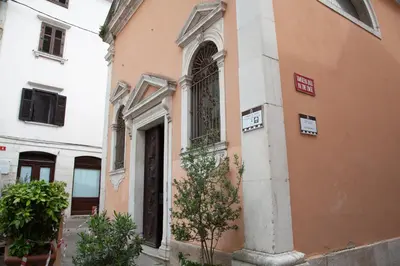 an orange building with a door on a street at Rosa di Pirano con Terrazza in Rove