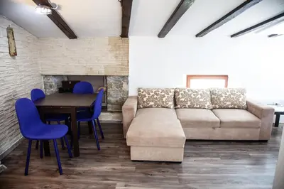 a living room with a couch and a table and chairs at Rosa di Pirano con Terrazza in Rove