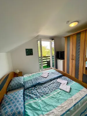 a bedroom with a large bed with towels on it at Quiet Forest Retreat with Pool in Borovnica