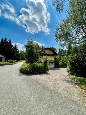 a house on the side of a road at Quiet Forest Retreat with Pool in Borovnica