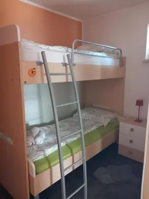 a bunk bed with a ladder in a room at Apartma ARNEJ in Kobarid