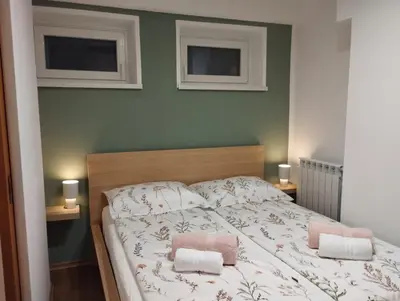 a bedroom with a bed with two towels on it at Apartma ARNEJ in Kobarid