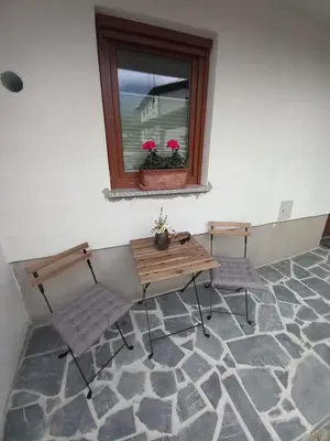 a room with a table and two chairs and a window at Apartma ARNEJ in Kobarid