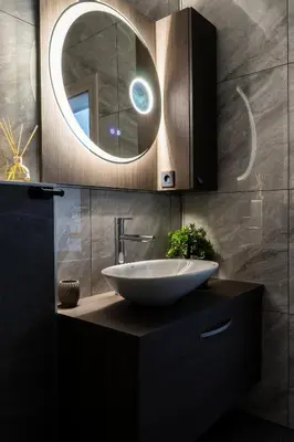 a bathroom with a sink and a mirror at Apartmaji na Pošti in Podsreda