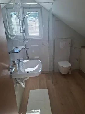 a bathroom with a sink and a toilet at APARTMA BriGITA in Gorica pri Slivnici