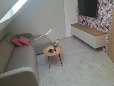 a small living room with a couch and a table at APARTMA BriGITA in Gorica pri Slivnici
