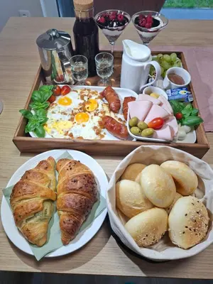 a table with two trays of breakfast food on it at APARTMA BriGITA in Gorica pri Slivnici