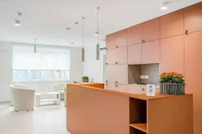 an open kitchen with orange and white cabinets at Prenočišča AUTUR in Tolmin