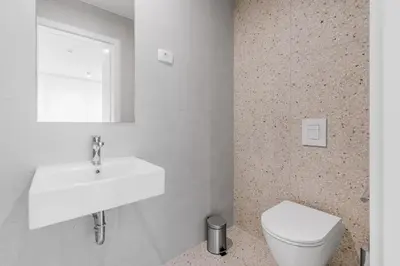 a bathroom with a white sink and a toilet at Prenočišča AUTUR in Tolmin