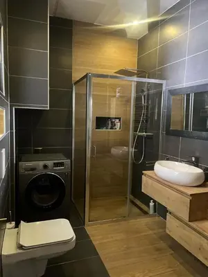 a bathroom with a shower and a toilet and a sink at City soul duplex apartment in Maribor