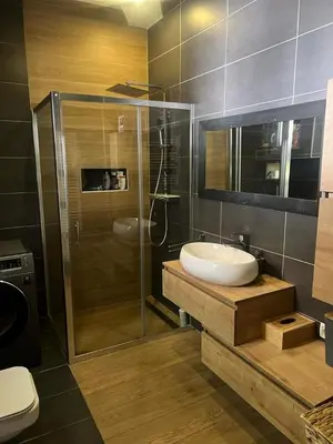 a bathroom with a sink and a glass shower at City soul duplex apartment in Maribor