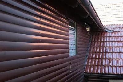 a wall of a house with wooden siding at Apartma ob Kolpi Križan in Gradac