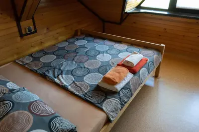 a bed in a room with two beds in a room at Apartma ob Kolpi Križan in Gradac