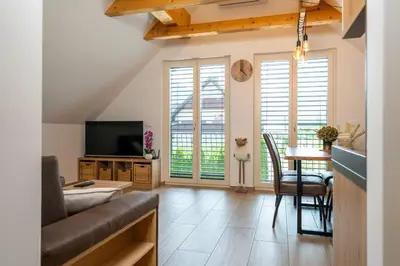 a living room with a couch and a table at Apartma Urška in Bohinj