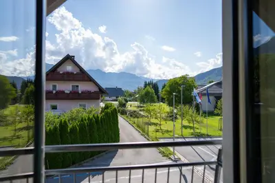 a view of a house from a window at Apartma Urška in Bohinj