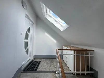a stairwell with a skylight and a window at Citybase Rooms in Ljubljana