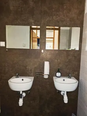 a bathroom with two sinks and a mirror at hostel Toper in Celje