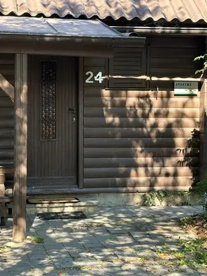 a house with a door with the number on it at Ferienhaus Čatež Holzhaus an der Therme Čatež in Brežice