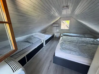 a room with two beds in a house at Ferienhaus Čatež Holzhaus an der Therme Čatež in Brežice