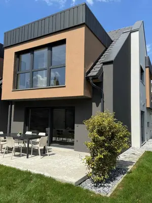 a house with a table and chairs in front of it at Modern Stay House Ptuj in Ptuj