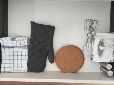 a shelf with two oven mitts on a shelf with a stove at Modern Stay House Ptuj in Ptuj