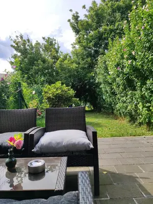 a patio with two chairs and a coffee table at Apartma Lastovka in Moravske Toplice