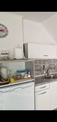 a kitchen with white cabinets and a sink at Apt Lublana in Ljubljana