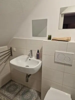 a white bathroom with a sink and a toilet at Apt Lublana in Ljubljana