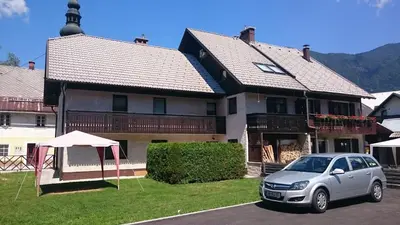 a car parked in front of a house at Apartment Šmon in Kranjska Gora