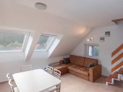 a living room with a couch and a table at Apartment Šmon in Kranjska Gora