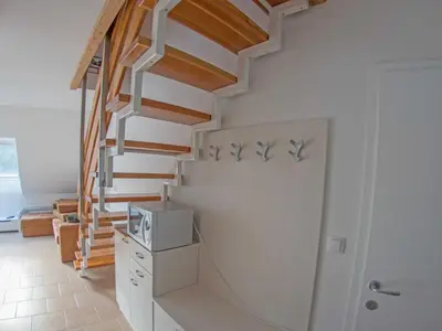 a staircase in a home with white walls and wooden floors at Apartment Šmon in Kranjska Gora