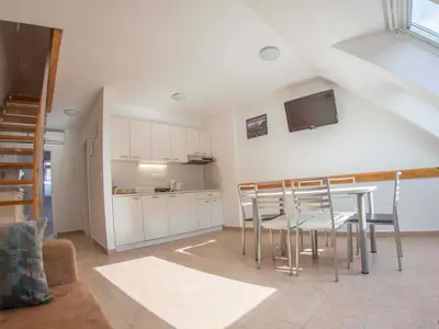 a kitchen and dining room with a table and chairs at Apartment Šmon in Kranjska Gora