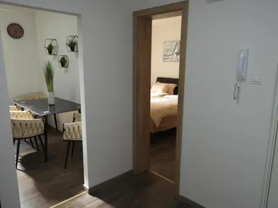 a room with a bed and a dining room with a table at ONYX Apartments in Ljubljana
