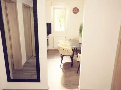 a dining room with a table and a mirror at ONYX Apartments in Ljubljana
