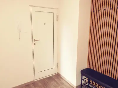 a white door in a room with a bench at ONYX Apartments in Ljubljana