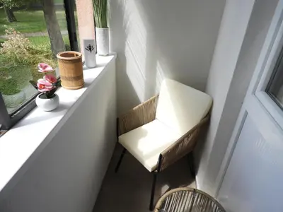 a white chair sitting on a window sill at ONYX Apartments in Ljubljana