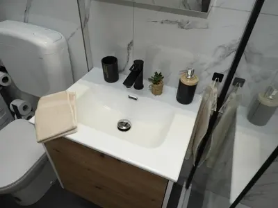 a bathroom with a white sink and a toilet at ONYX Apartments in Ljubljana
