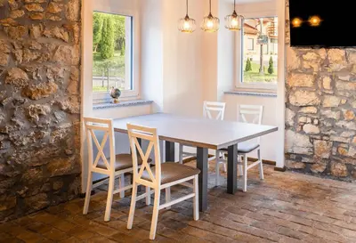 a dining room with a table and chairs at Lipa Plac in Postojna