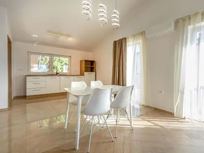 a dining room with a white table and white chairs at Apartment Adelsberg Inn-1 by Interhome in Postojna