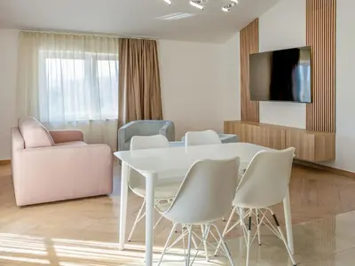 a white dining room with a white table and chairs at Apartment Adelsberg Inn-1 by Interhome in Postojna