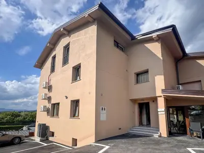 a building with a car parked in a parking lot at Apartment Adelsberg Inn-1 by Interhome in Postojna