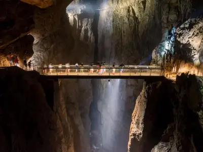 a group of people standing on a bridge in a cave at Apartment Adelsberg Inn-1 by Interhome in Postojna