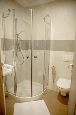 a bathroom with a shower and a toilet at Garni Hotel Krško in Leskovec pri Krškem