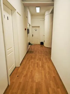 an empty hallway with wood floors and white walls at Hostel pod gradom in Celje