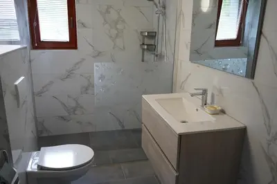 a bathroom with a sink and a toilet at Apartma Mlinca 1 in Mojstrana