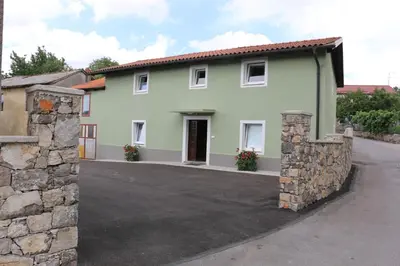 a house with a driveway in front of it at Apartmaji Lukovi in Obrov