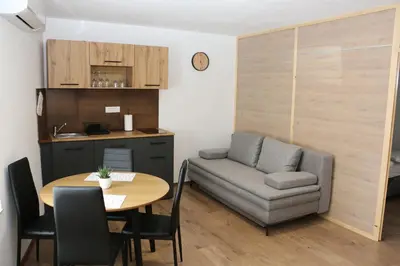 a small living room with a table and a couch at Apartmaji Lukovi in Obrov