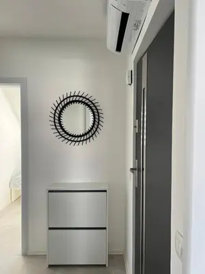 a mirror on the wall of a room with a hallway at Natura Apartments in Kranj