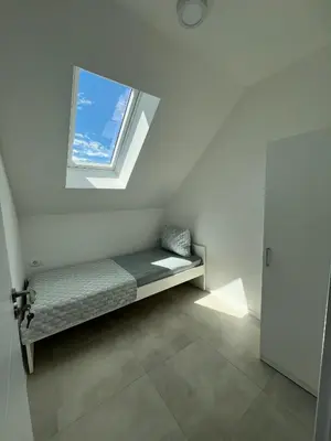 a small room with a bench with a window at Natura Apartments in Kranj